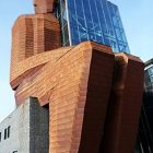 Surreal vertical castle with turrets and floating gardens on blue sky