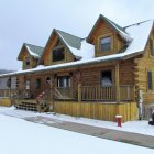 Snow-covered multi-story wooden house at twilight with intricate balconies in snowy landscape