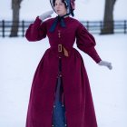 Woman in Red Dress with Short Auburn Hair in Snowy Landscape