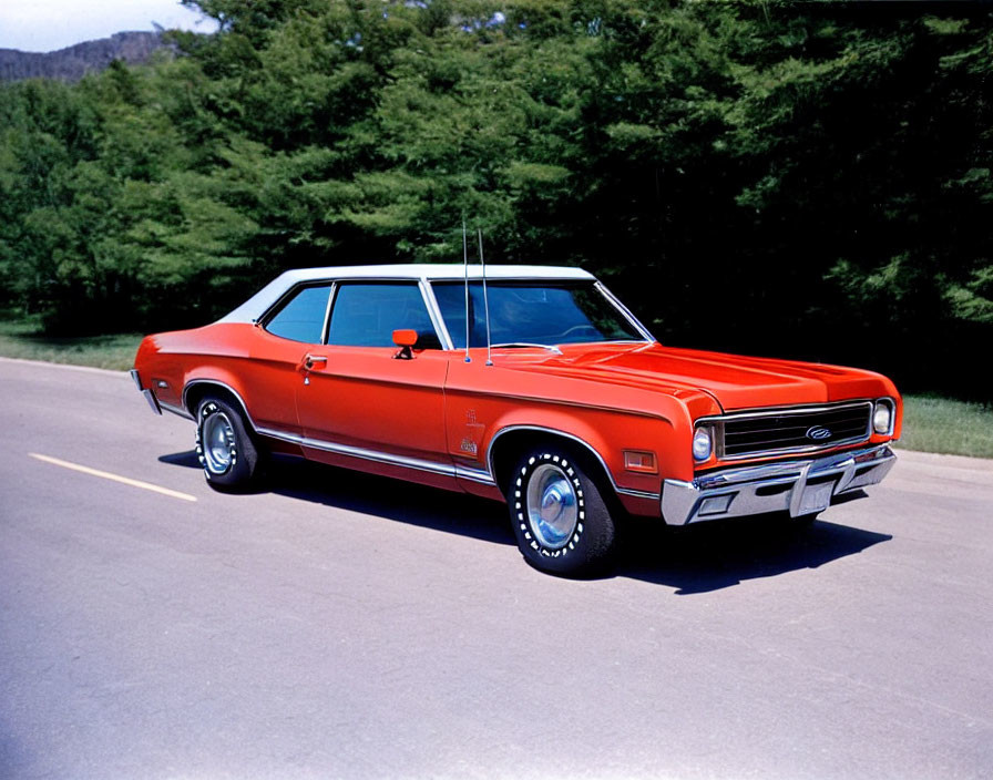 Vintage Red Car with Chrome Details and White-Striped Tires Outdoors