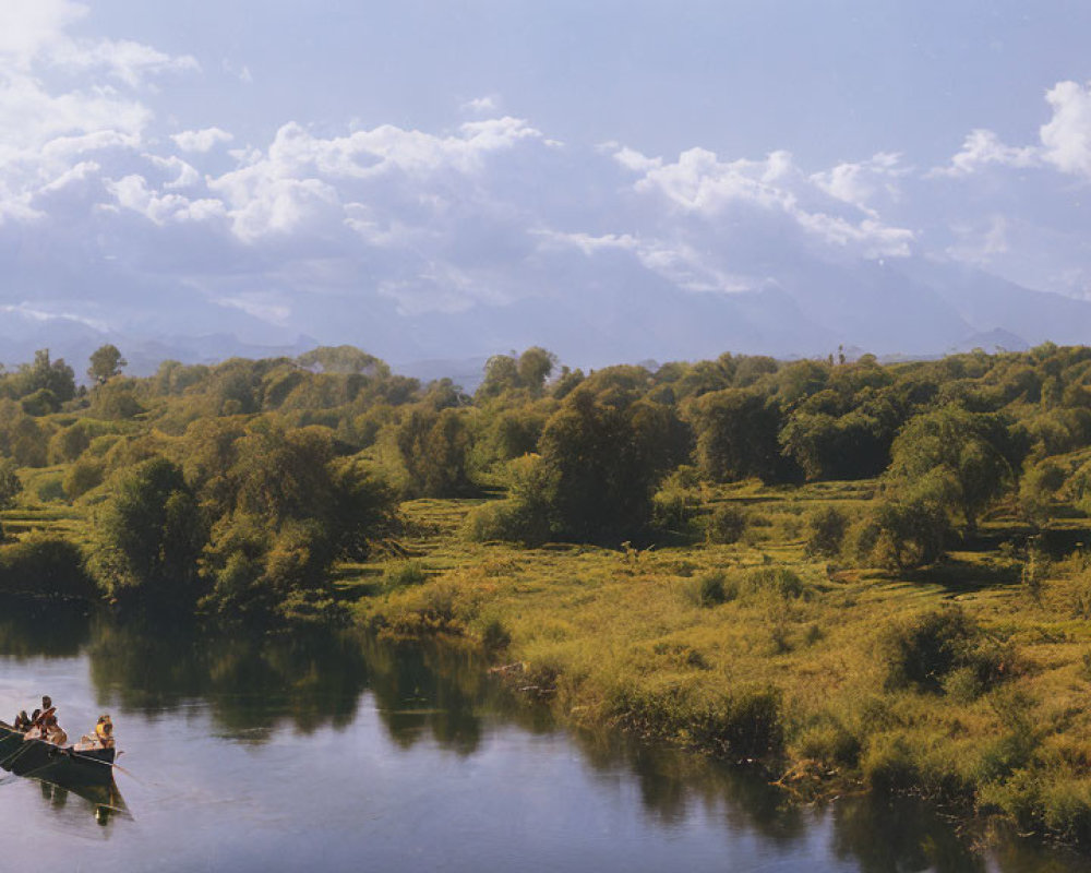 Tranquil river scene with rowing boat, greenery, sky, mountains