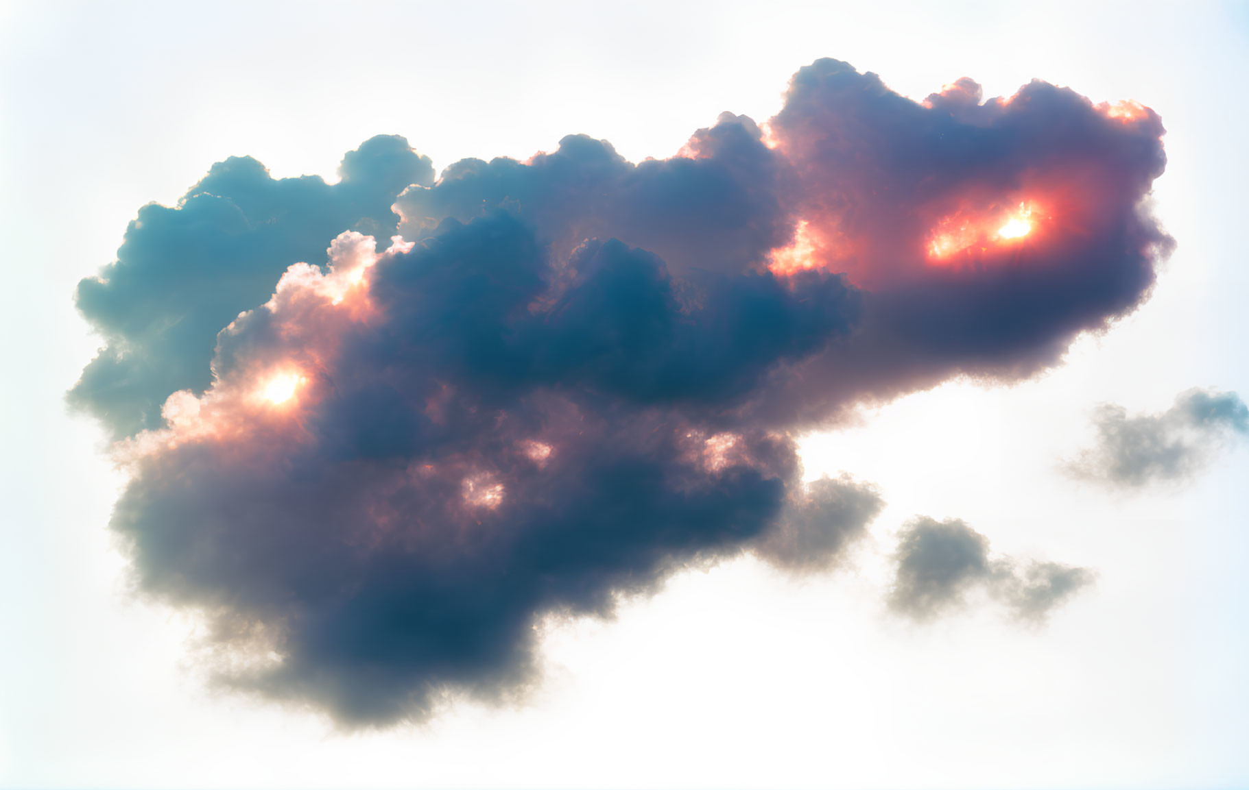 Dramatic dark cloud with sunlight creating radiant flares