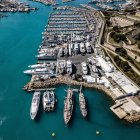 Futuristic port with towering structures and ships in golden sunlight