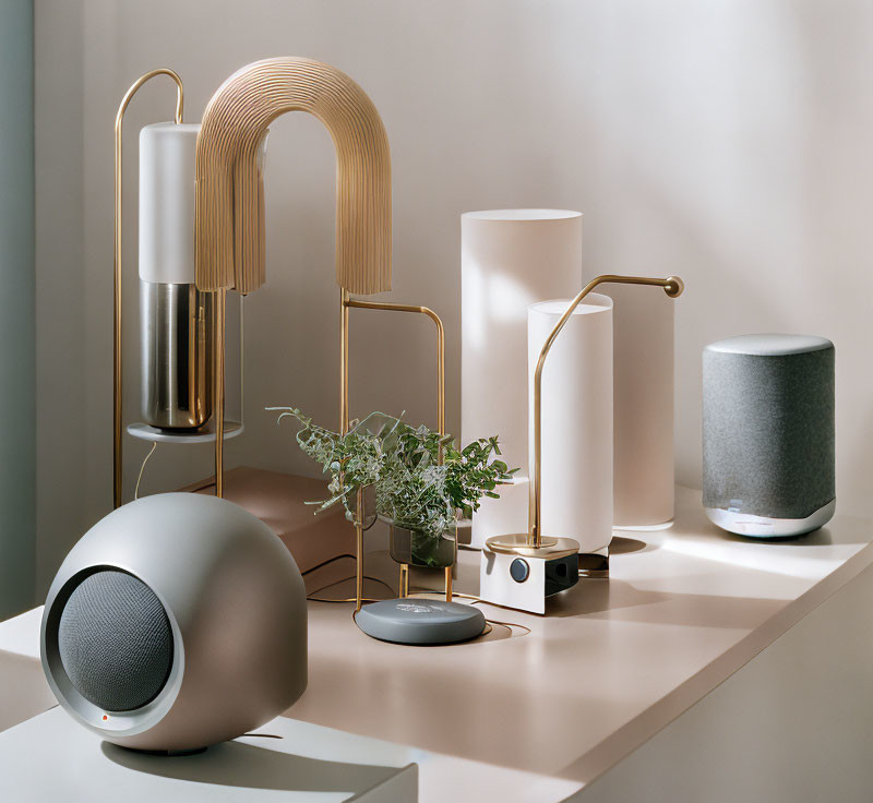 Stylish modern home decor with lamps, speaker, plants, and smart device