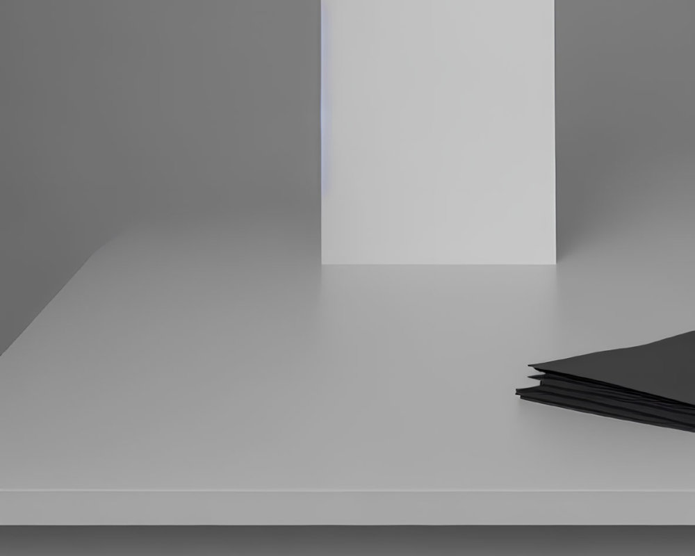 White canvas on grey tabletop with black sheets, grey background