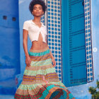 Bohemian-styled woman in colorful skirt and edgy haircut in ornate blue space