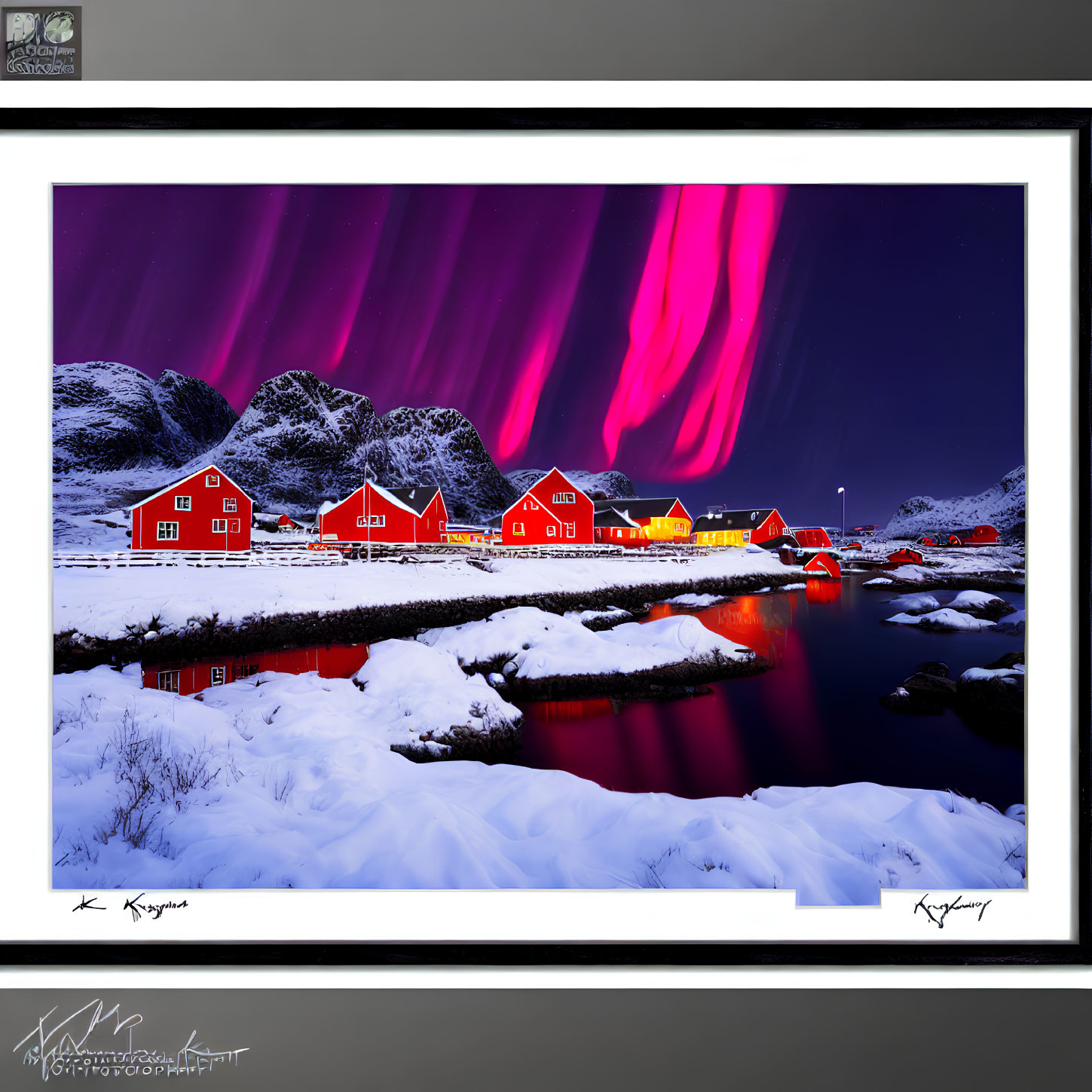 Colorful aurora borealis over red houses in snowy landscape with water reflections