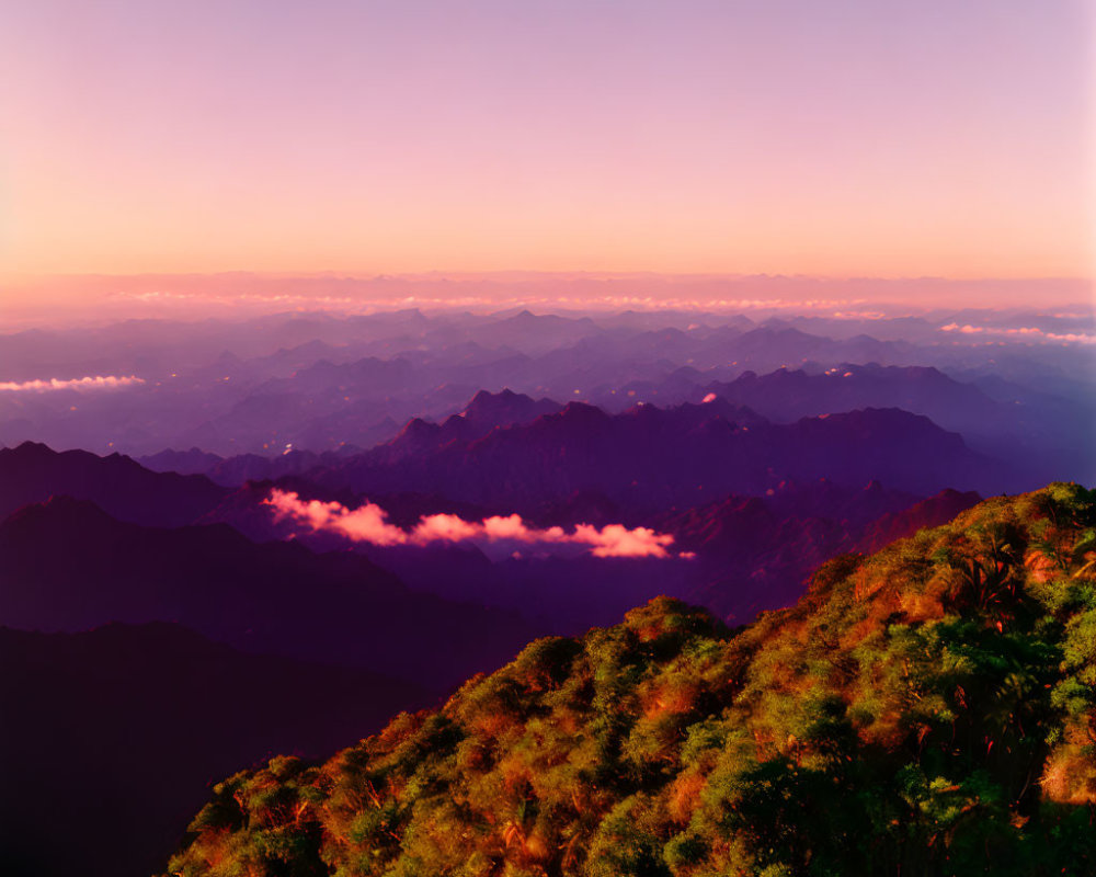 Scenic mountain landscape at sunrise with lush greenery and clouds