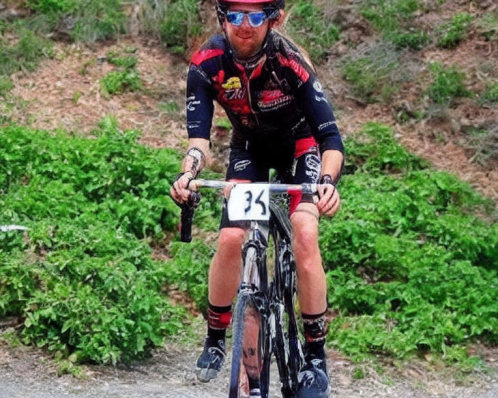 Cyclist in Black and Red Kit with Number 35 Riding Uphill