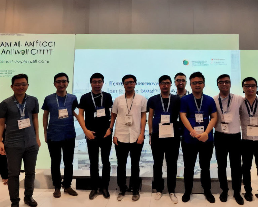 Nine Men in Professional Attire Smiling Before Conference Banner