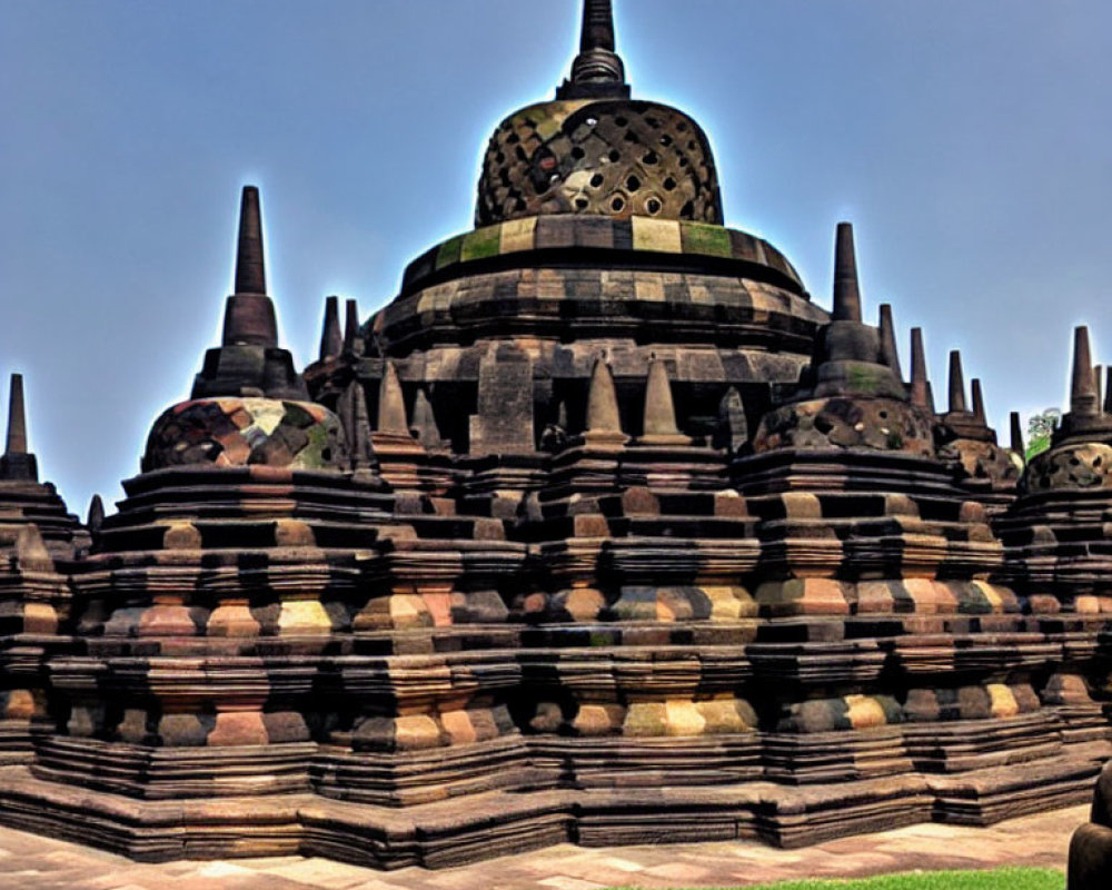 Ancient Buddhist stupa with multiple spires under blue sky