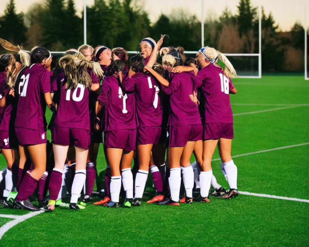 Women's Soccer Team Celebrates in Maroon Jerseys at Dusk