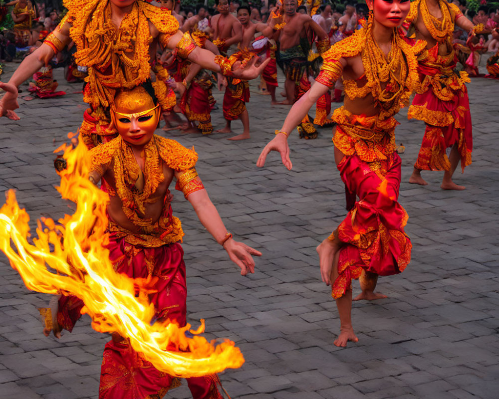 Traditional Dancers in Ornate Costumes Perform with Fire Outdoors