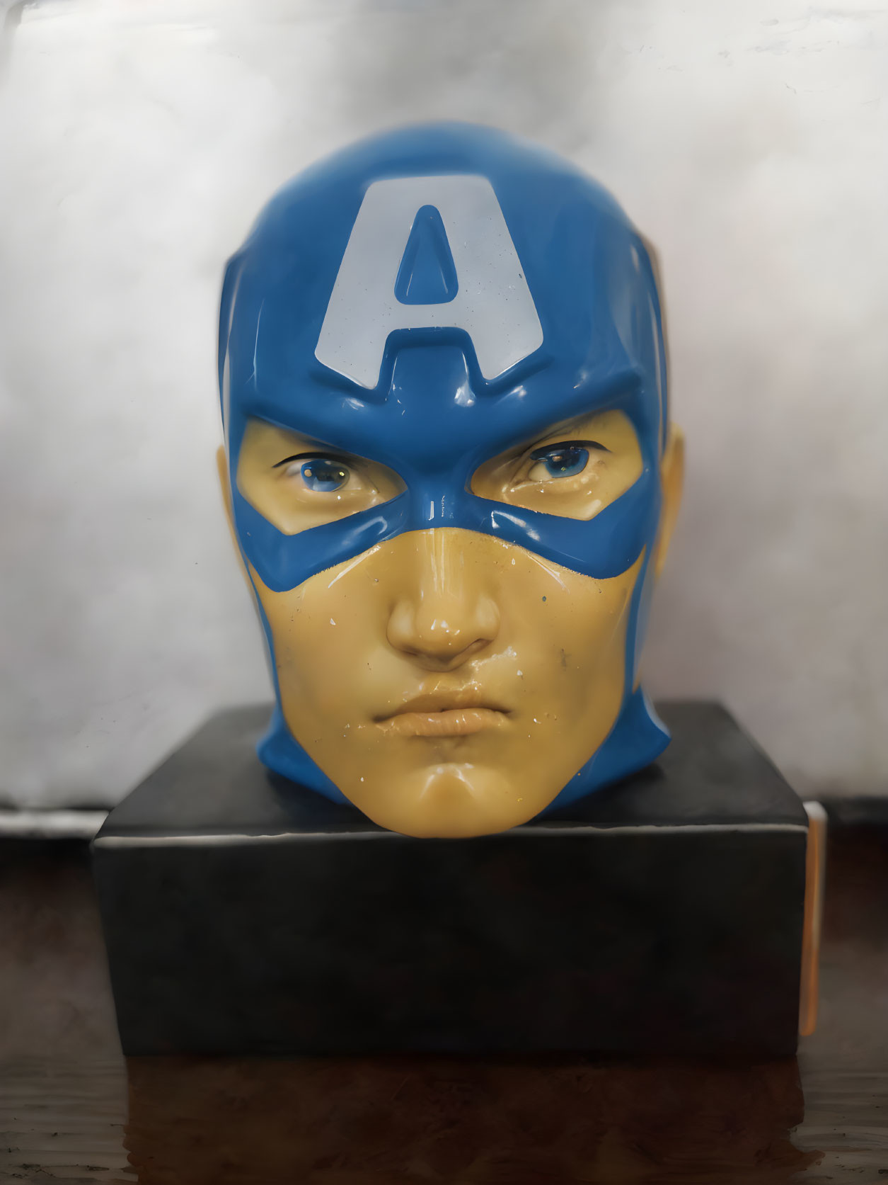 Realistic Captain America bust with stern expression and blue helmet on pedestal