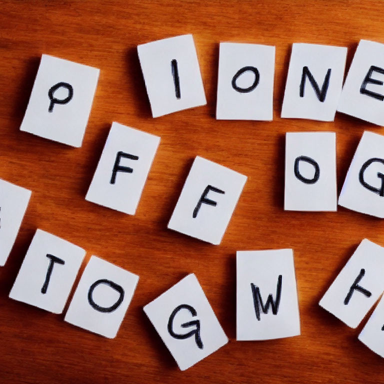 Square Letter Tiles on Wooden Surface for Word Game or Educational Activity