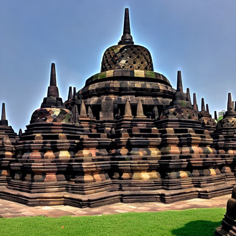 Ancient Buddhist stupa with multiple spires under blue sky