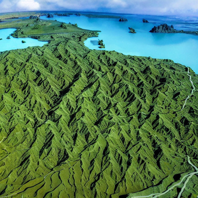 Scenic aerial view of green hilly terrain and blue water with islands