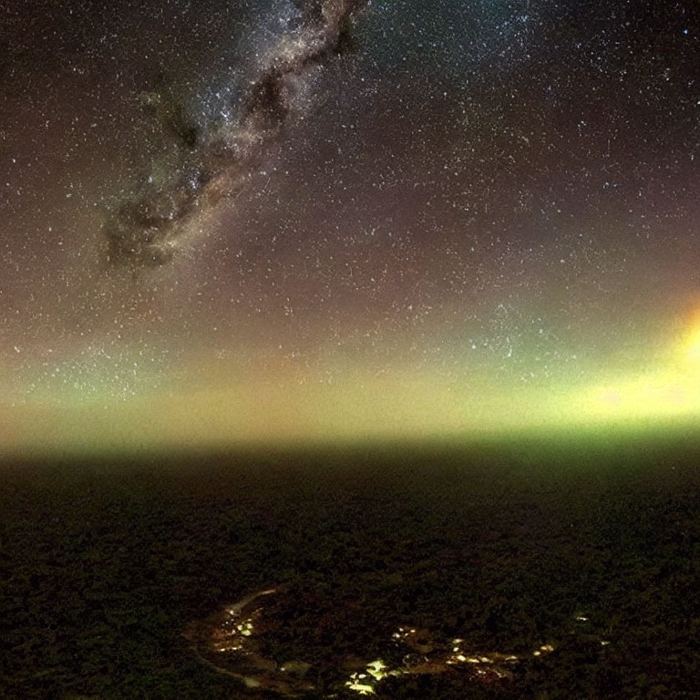 Starry Night Sky with Milky Way and Aurora above Dimly Lit Landscape