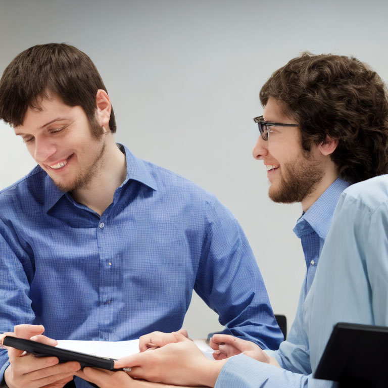 Two Men in Blue Shirts Having a Friendly Conversation