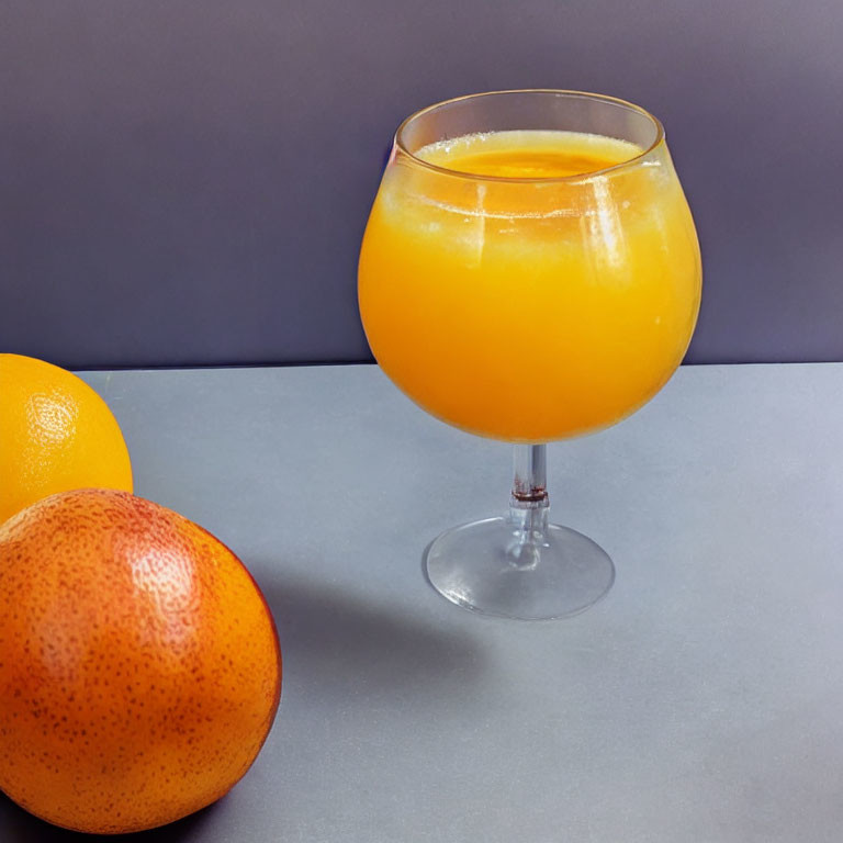 Fresh orange juice with two whole oranges on grey surface against purple backdrop