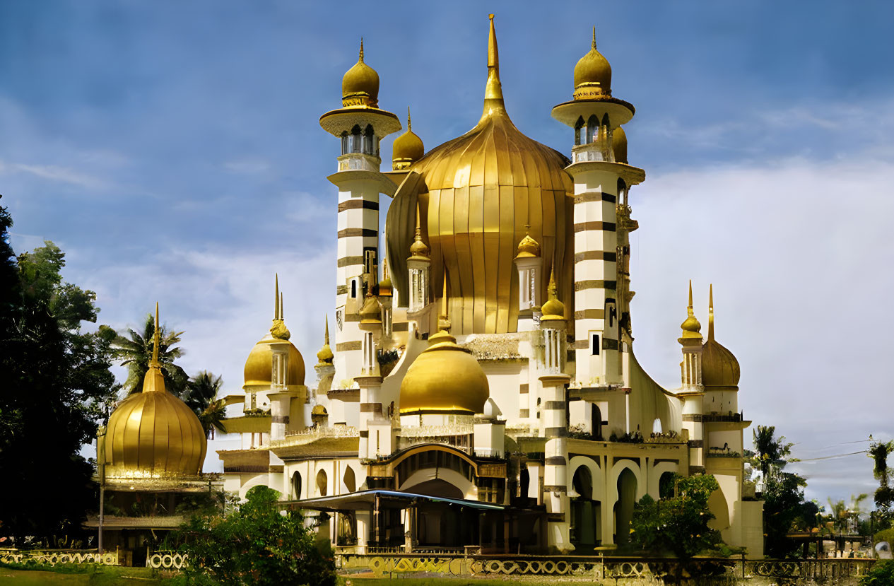 Grand Mosque with Golden Domes and Minarets Amid Lush Greenery