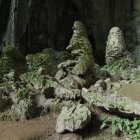 Enchanting cave with vibrant foliage, glowing plants, unique rocks, and a wooden boat