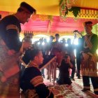 Traditional Attire Ceremony with Colorful Decor and Audience