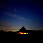 Night Sky Illuminated Tents in Dark Campsite