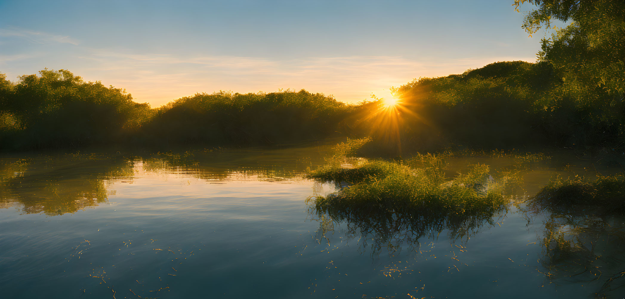 Tranquil river at sunset with sunlight through dense foliage