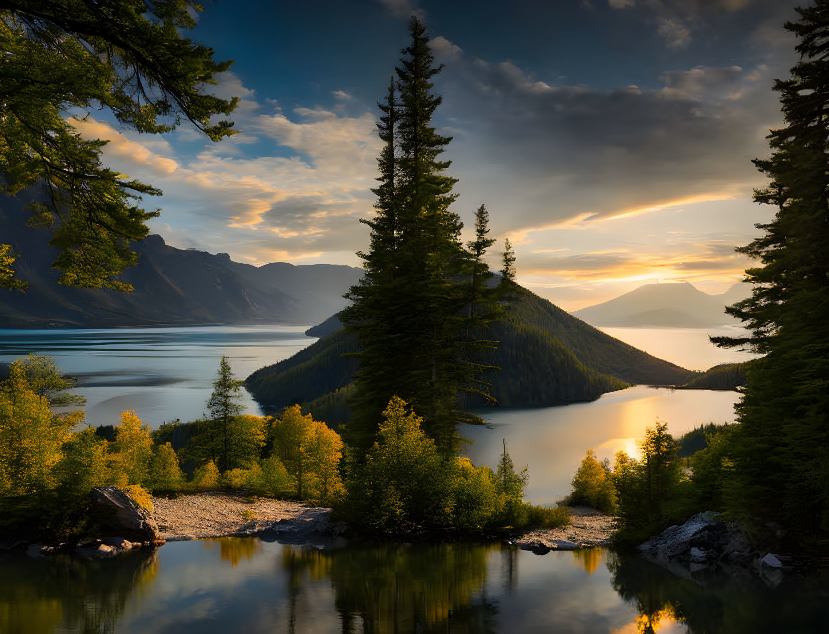 Tranquil sunset scene: lake, forested island, mountains, pine trees.