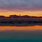 Fiery red-orange foliage landscape with dramatic sky and stars reflected in water