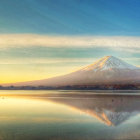 Golden sand dunes and snow-capped mountains in serene desert landscape