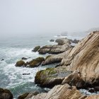 Tranquil Coastal Landscape with Rocky Shore and Calm Sea