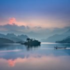 Mystical landscape with ethereal buildings and floating structures reflected in tranquil water