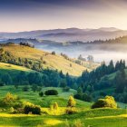 Serene Landscape with Rolling Hills and Misty Valleys