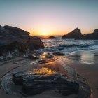 Picturesque Rocky Beach Sunset with Unique Geological Formations