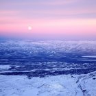 Surreal landscape with wave-like mountains and moonlit sea