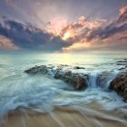 Dramatic seascape with crashing waves and sunset sky