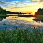 Surreal sunset landscape with reflective lake and intricate foliage