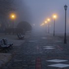 Misty Cobblestone Path with Glowing Street Lamps