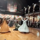 Graceful Dance Performance in Sunlit Hall with Reflective Floor