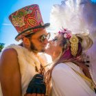 Stylized painting of man in top hat getting kiss from woman