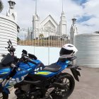 Shiny motorcycle with helmet in front of majestic castle