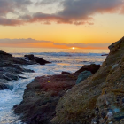 Vibrant sunset over rugged coastline with impressionist brushstrokes