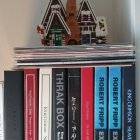 Blue-horned figurine on colorful books shelf