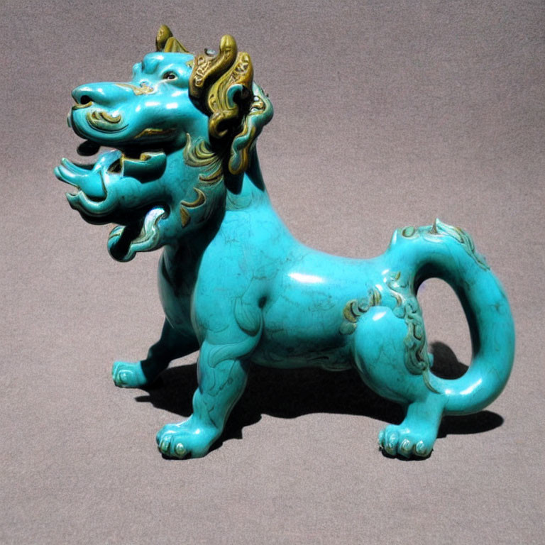 Intricate Turquoise and Gold Chinese Guardian Lion Figurine on Grey Background