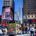 Vibrant cityscape illustration with pedestrians, vendors, vehicles, and skyscrapers under a blue