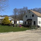 Rustic wooden houses and horse in flower-filled landscape