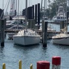 Colorful Whimsical Dock Scene with Boats and Lone Figure