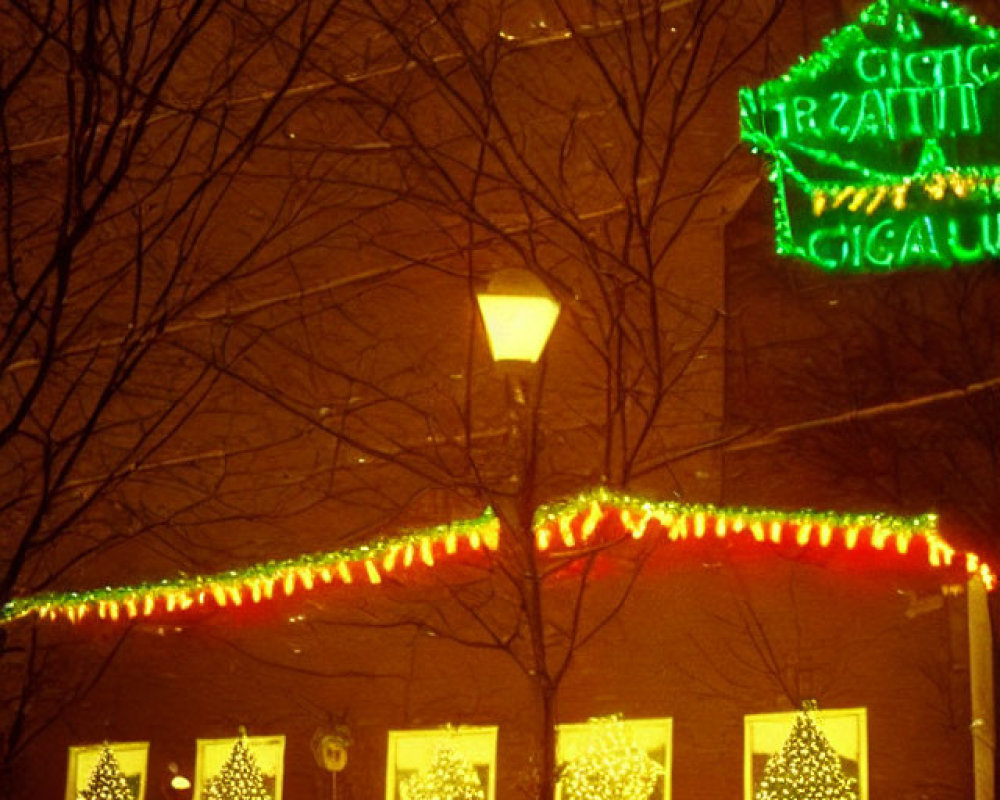 Snow-covered brick building with Christmas lights and wreaths, glowing streetlamp and neon sign.